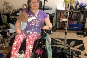 me in my wheelchair, all dressed up in one of the outfits Jeff picked out for me because he was so in love with me. My IV nags and tube feedings are on the IV pole next to me